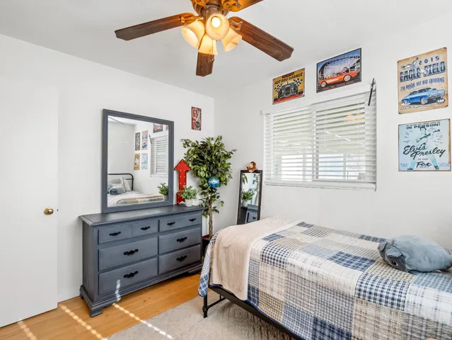 a bedroom with a bed and a dresser in it