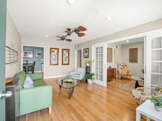 a living room with furniture dining table and wooden floor