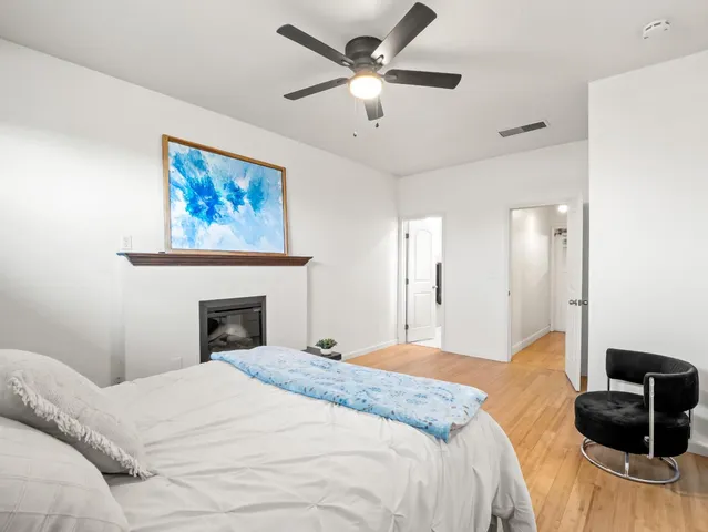 a bedroom with a bed and a ceiling fan