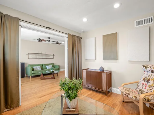 a living room with furniture and a potted plant