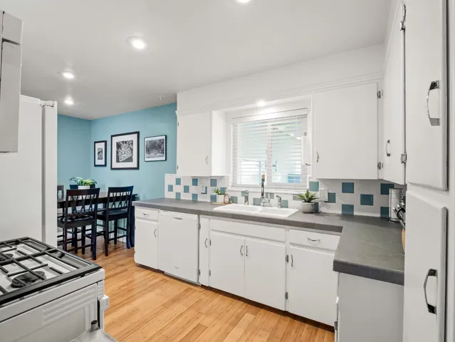 a kitchen with a sink stove and cabinets