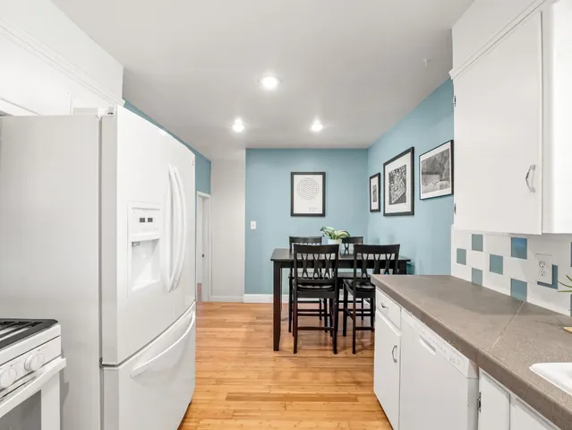 a kitchen with stainless steel appliances granite countertop a refrigerator and a stove top oven