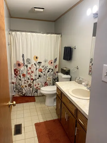 a bedroom with a bed and a tv