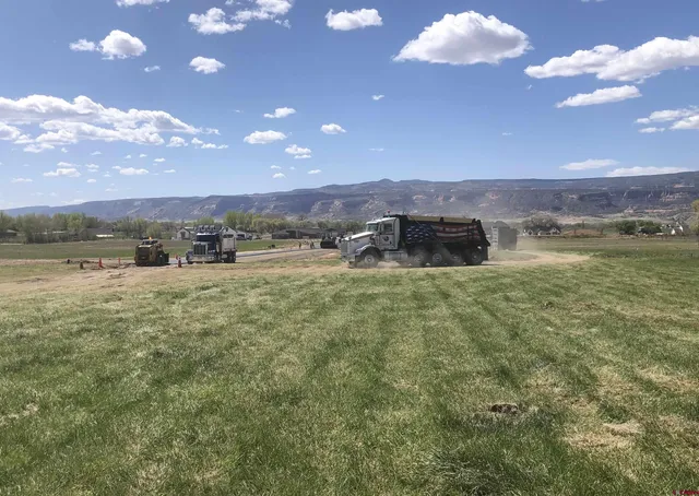 a view of a city with lots of residential buildings and mountain view in back