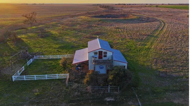 a aerial view of a house with a yard