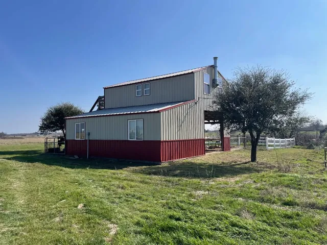 a front view of house with yard and trees