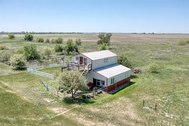 an aerial view of a house with a yard