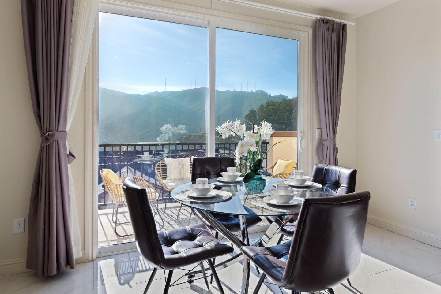 147 Elderberry Lane Brisbane, CA 94005 - Photo 16 of 56 a dining room with furniture a rug and a floor to ceiling window