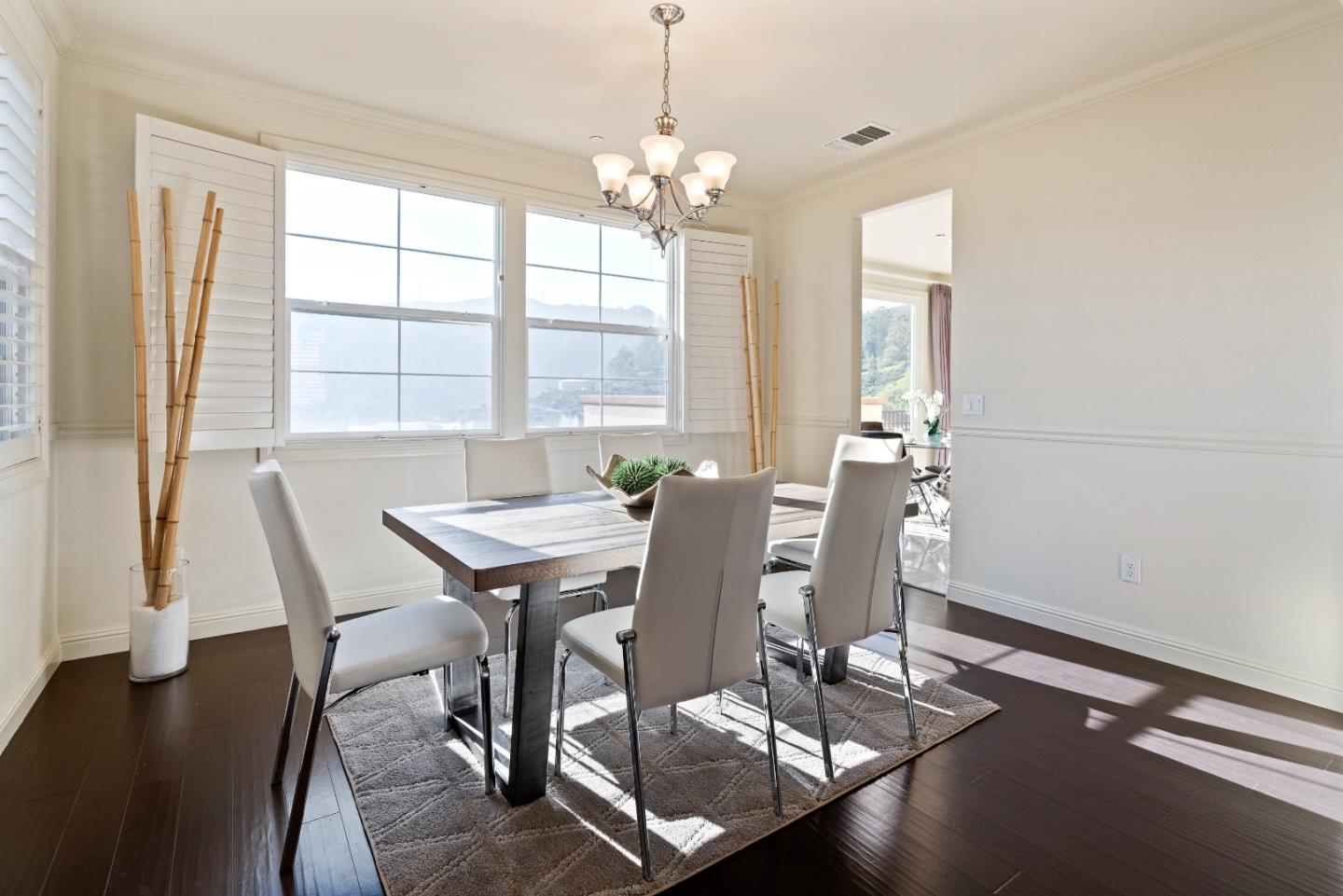 147 Elderberry Lane Brisbane, CA 94005 - Photo 23 of 56 a view of a dining room with furniture and wooden floor