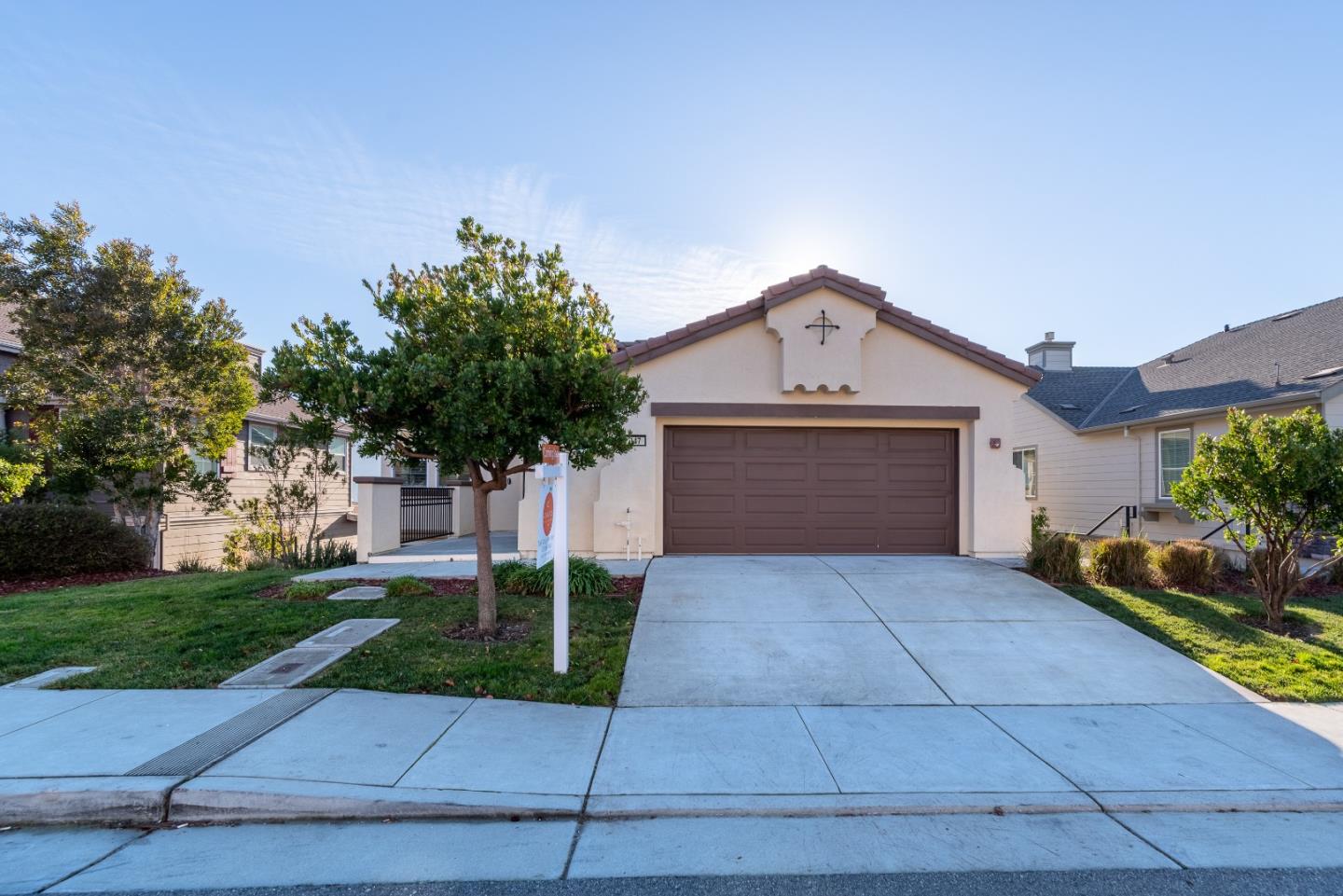 147 Elderberry Lane Brisbane, CA 94005 - Photo 3 of 56 a front view of a house with a yard and garage