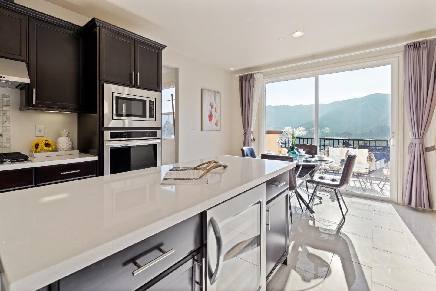 147 Elderberry Lane Brisbane, CA 94005 - Photo 4 of 56 a kitchen with a stove a sink and a refrigerator