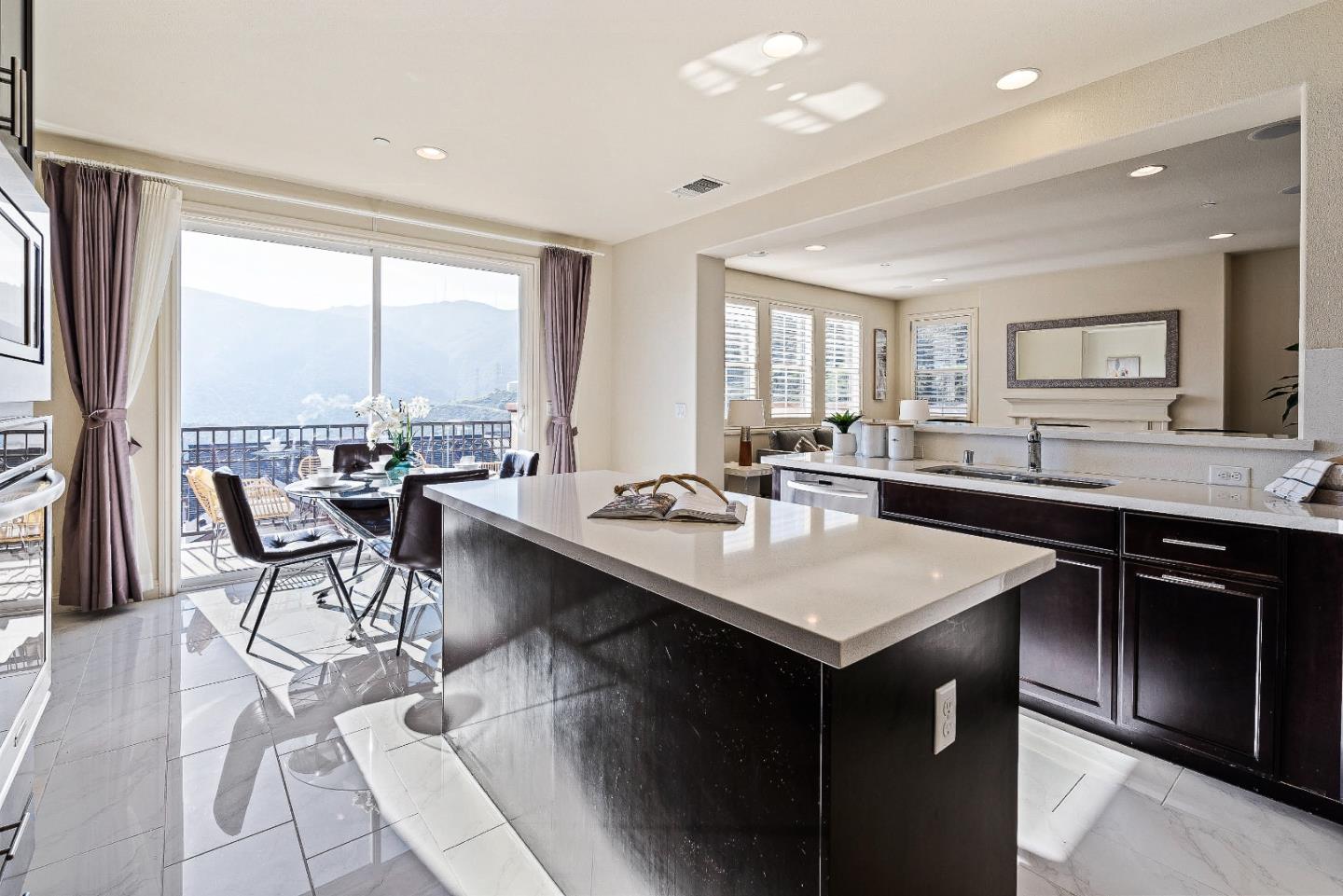 147 Elderberry Lane Brisbane, CA 94005 - Photo 5 of 56 a kitchen with counter top space a sink cabinets and appliances