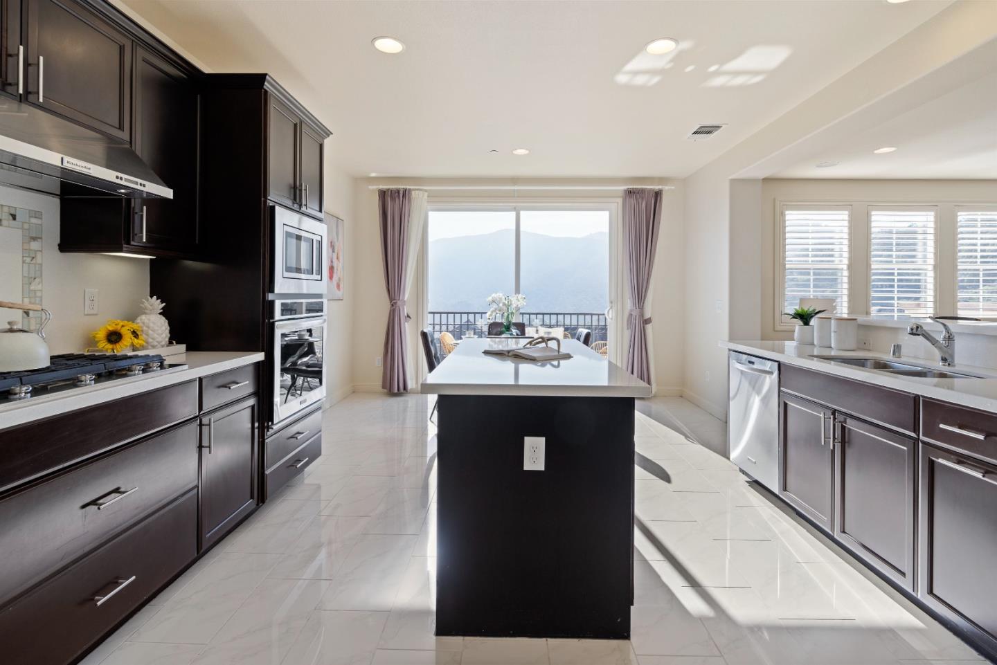 147 Elderberry Lane Brisbane, CA 94005 - Photo 6 of 56 a kitchen with stainless steel appliances kitchen island granite countertop a refrigerator and a sink