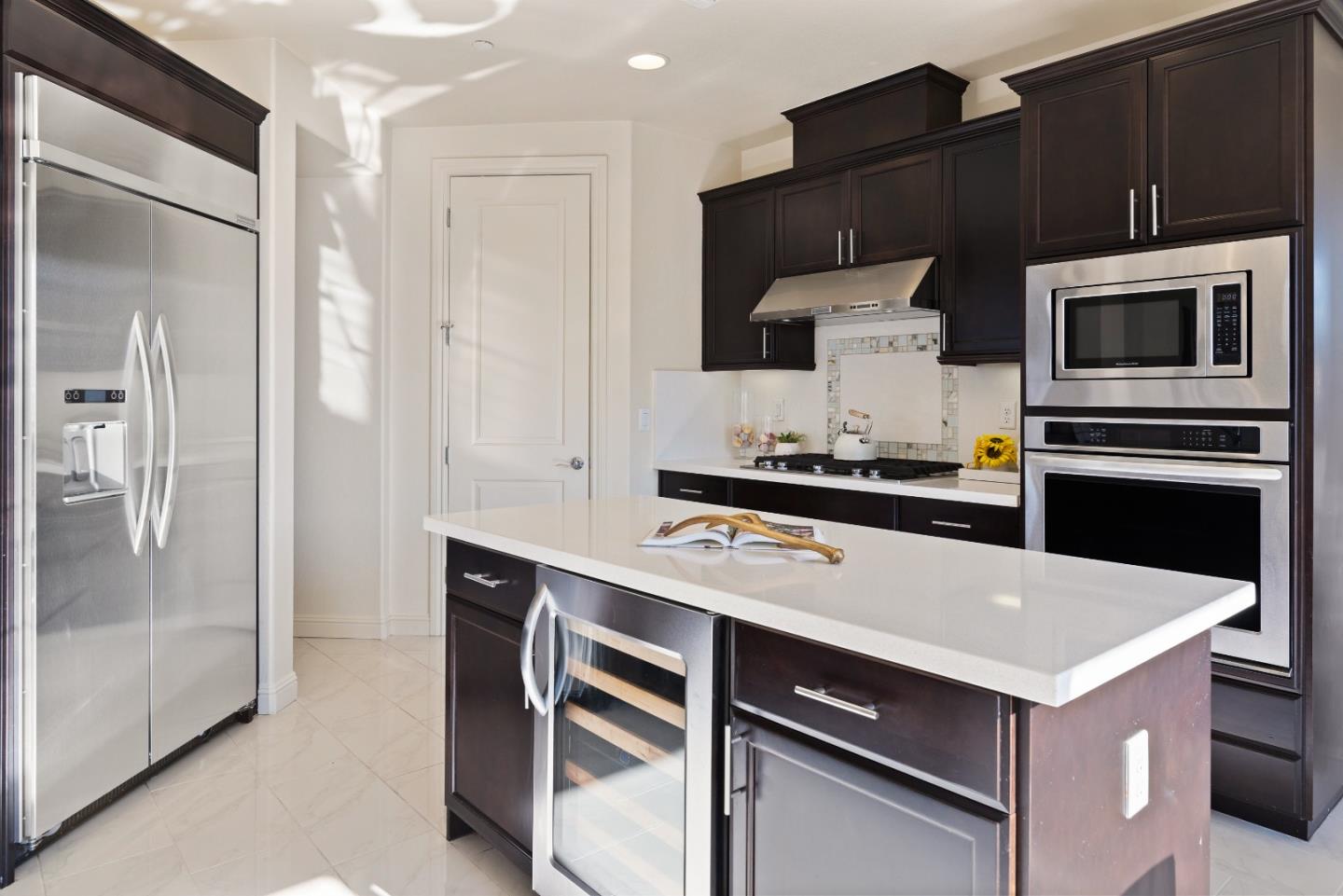 147 Elderberry Lane Brisbane, CA 94005 - Photo 8 of 56 a kitchen with a refrigerator stove and cabinets