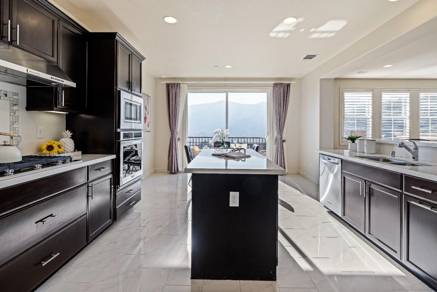 147 Elderberry Lane Brisbane, CA 94005 - Photo 9 of 56 a kitchen with stainless steel appliances kitchen island granite countertop a stove a sink and a refrigerator