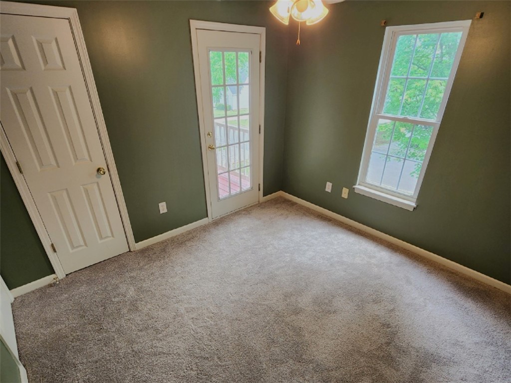 328 Springfield Circle Easley, SC 29642 - Photo 23 of 29 A cozy bedroom with a private balcony access, ideal for unwinding.