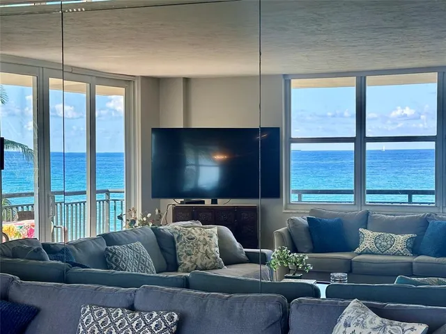 a living room with couches and a flat screen tv