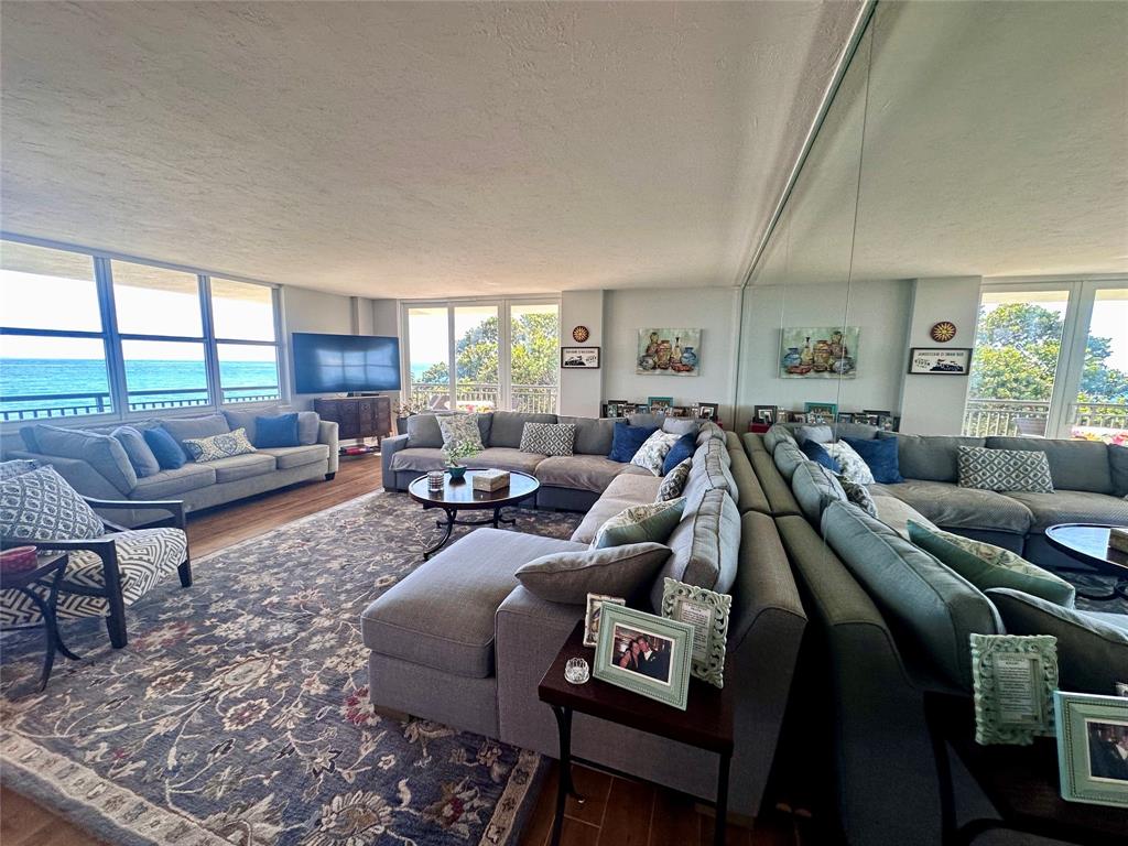 1147 Hillsboro Mile, Unit 214 Hillsboro Beach, FL 33062 - Photo 12 of 43 a living room with furniture and a large window