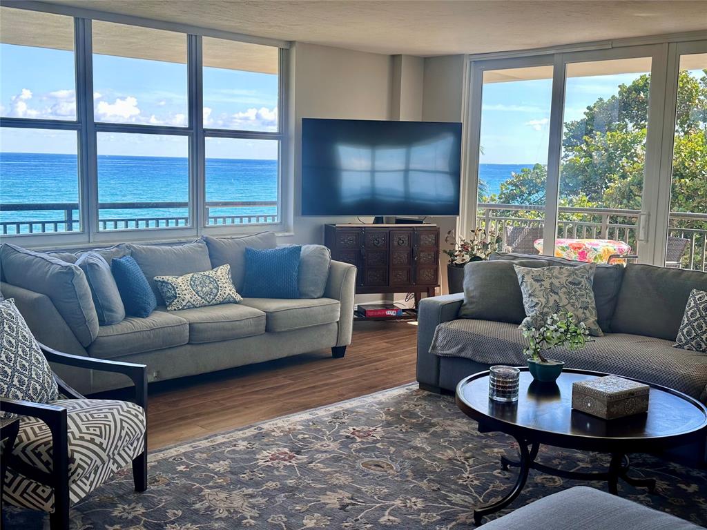 1147 Hillsboro Mile, Unit 214 Hillsboro Beach, FL 33062 - Photo 15 of 43 a living room with furniture and a large window