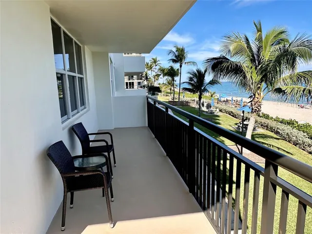 a view of a chairs and table in a balcony