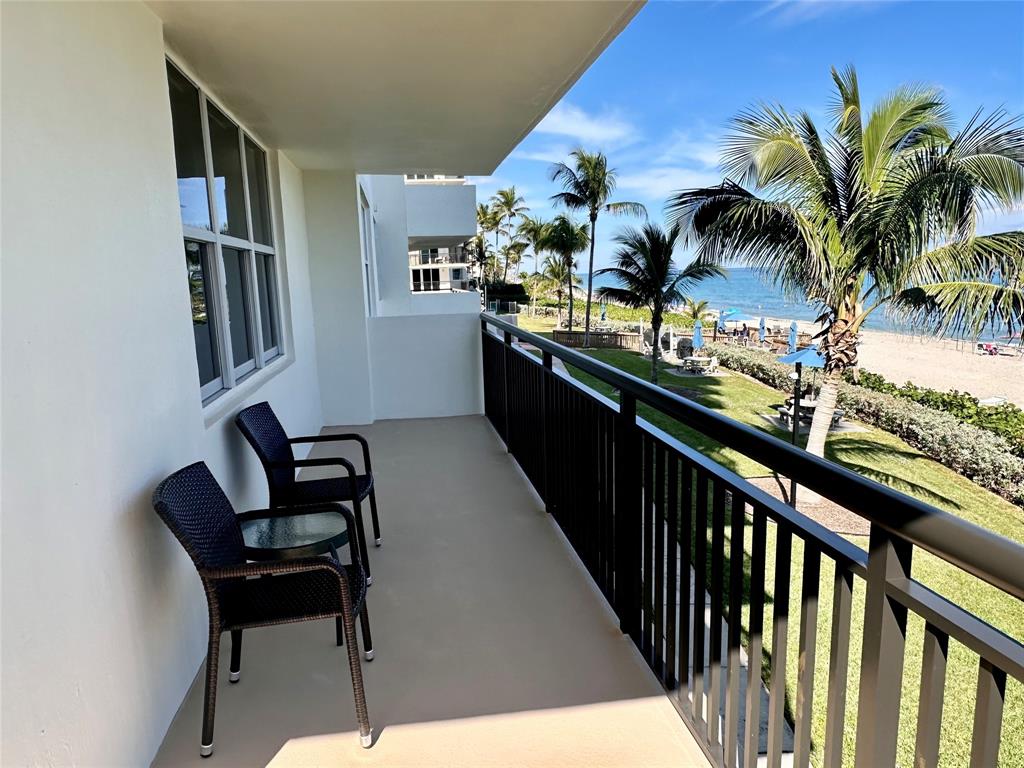 1147 Hillsboro Mile, Unit 214 Hillsboro Beach, FL 33062 - Photo 16 of 43 a view of a chairs and table in a balcony