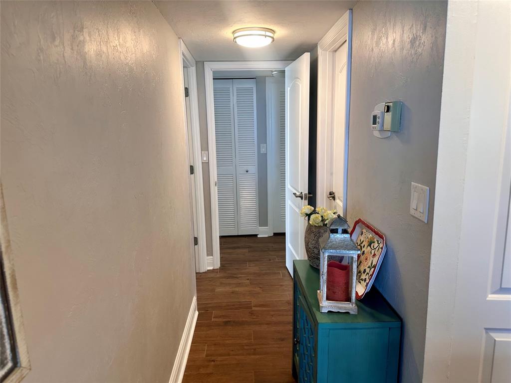 1147 Hillsboro Mile, Unit 214 Hillsboro Beach, FL 33062 - Photo 23 of 43 a view of a hallway with wooden floor and closet