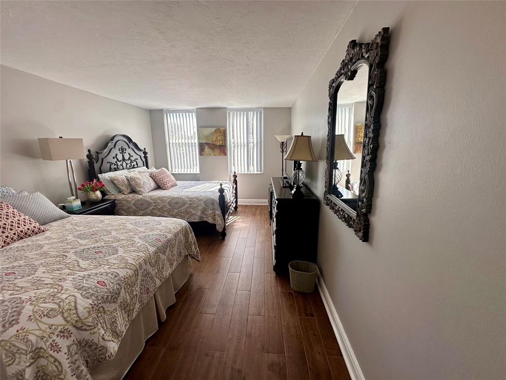 1147 Hillsboro Mile, Unit 214 Hillsboro Beach, FL 33062 - Photo 24 of 43 a bed room with double bed and a window