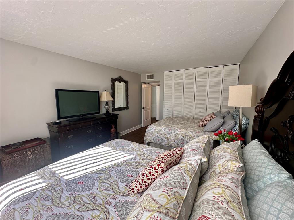 1147 Hillsboro Mile, Unit 214 Hillsboro Beach, FL 33062 - Photo 25 of 43 a bedroom with a bed and a flat screen tv