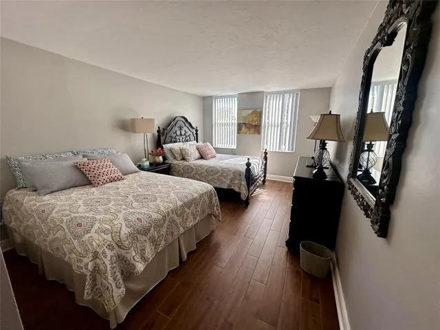 a bed room with two beds and a window