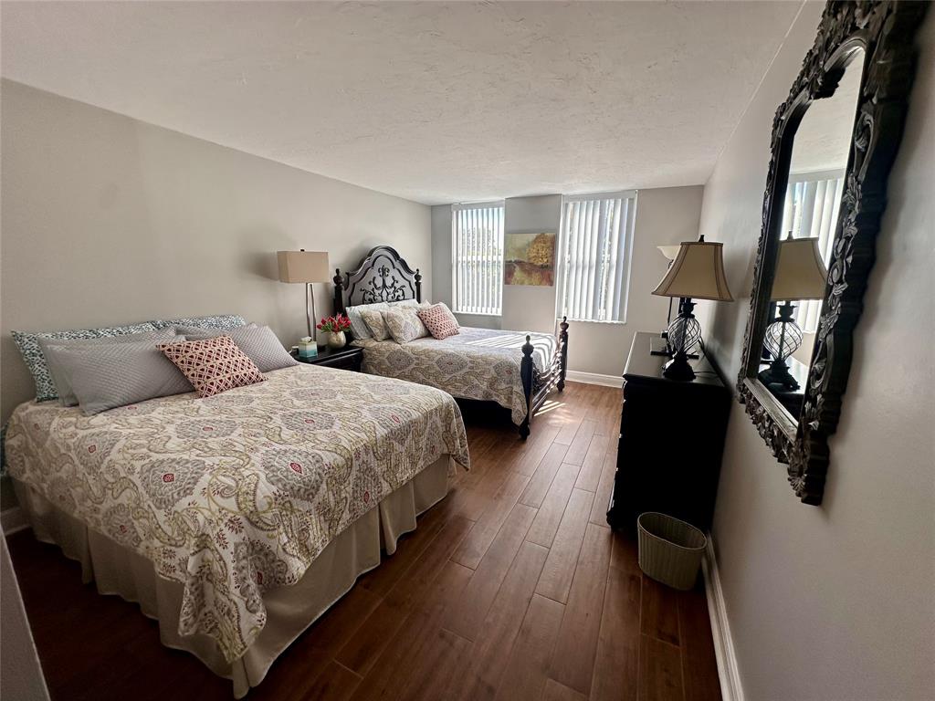 1147 Hillsboro Mile, Unit 214 Hillsboro Beach, FL 33062 - Photo 26 of 43 a bed room with two beds and a window