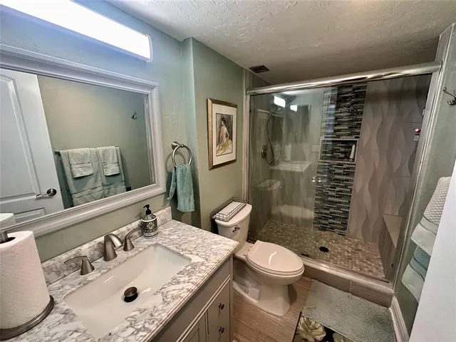 a bathroom with a sink toilet and shower