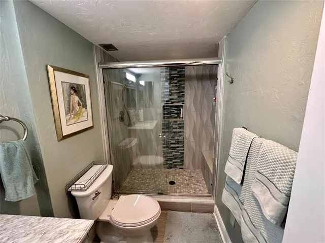 a bathroom with a toilet and shower