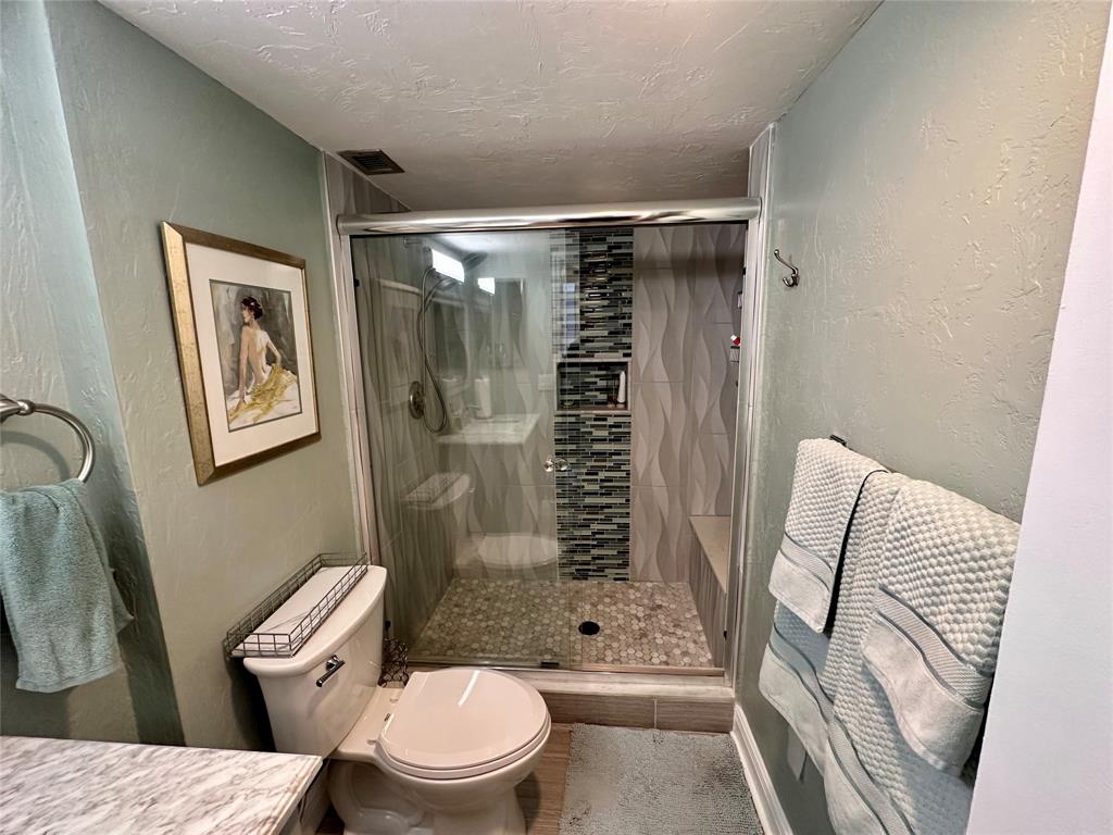 1147 Hillsboro Mile, Unit 214 Hillsboro Beach, FL 33062 - Photo 28 of 43 a bathroom with a toilet and shower