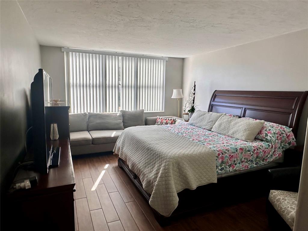 1147 Hillsboro Mile, Unit 214 Hillsboro Beach, FL 33062 - Photo 30 of 43 a bedroom with a bed couch and a window