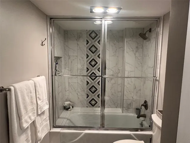 a bathroom with a bathtub and shower