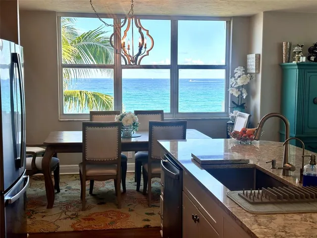 a kitchen with a table chairs and a window