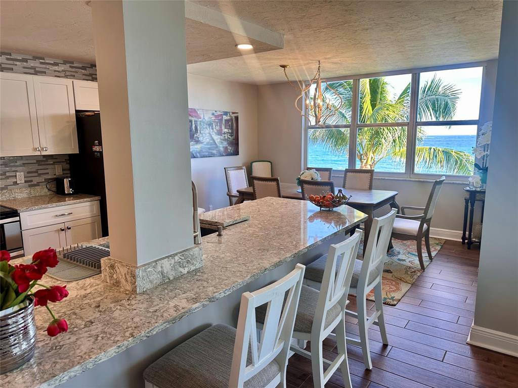 1147 Hillsboro Mile, Unit 214 Hillsboro Beach, FL 33062 - Photo 5 of 43 a view of a dining room with furniture window and wooden floor