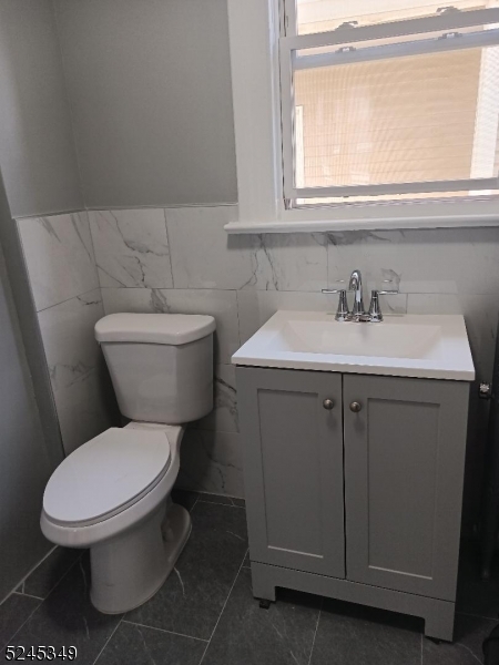 57 Maolis Avenue, Unit 2 Bloomfield, NJ 07003 - Photo 11 of 11 a white toilet sitting next to a bathroom sink