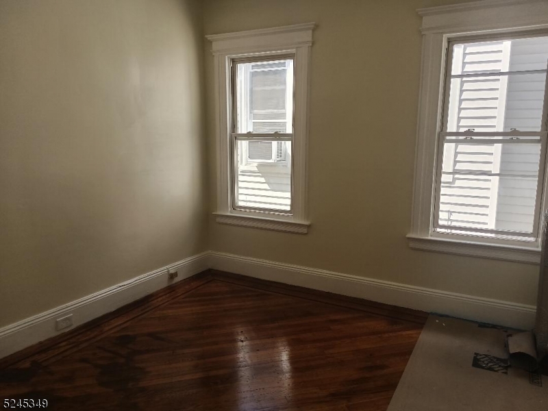 57 Maolis Avenue, Unit 2 Bloomfield, NJ 07003 - Photo 3 of 11 a view of a room with wooden floor and a window