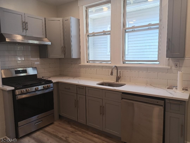 57 Maolis Avenue, Unit 2 Bloomfield, NJ 07003 - Photo 5 of 11 a kitchen with stainless steel appliances a stove a sink and a window