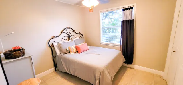 a bedroom with a bed and a window