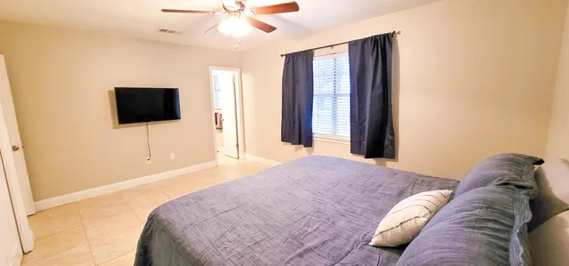 a bedroom with a bed and a flat screen tv