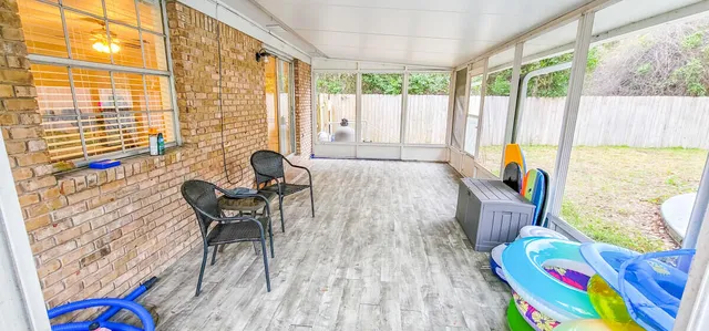 a living room filled with furniture and a floor to ceiling window