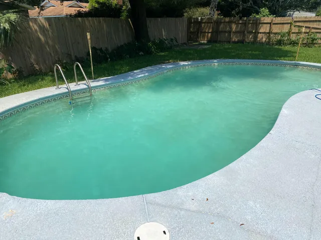 a view of a chair and table in the garden