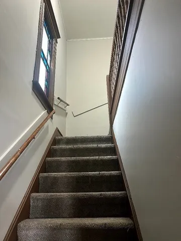 a view of staircase with wooden floor and stair