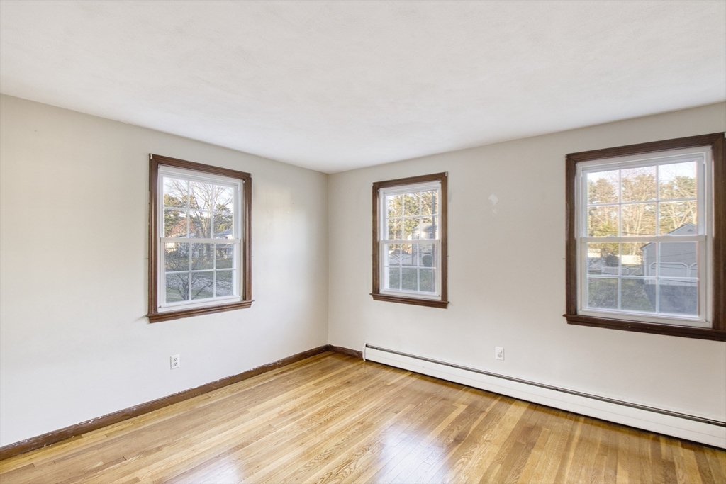 17 Colt Road Franklin, MA 02038 - Photo 23 of 40 a view of an empty room with wooden floor and a window
