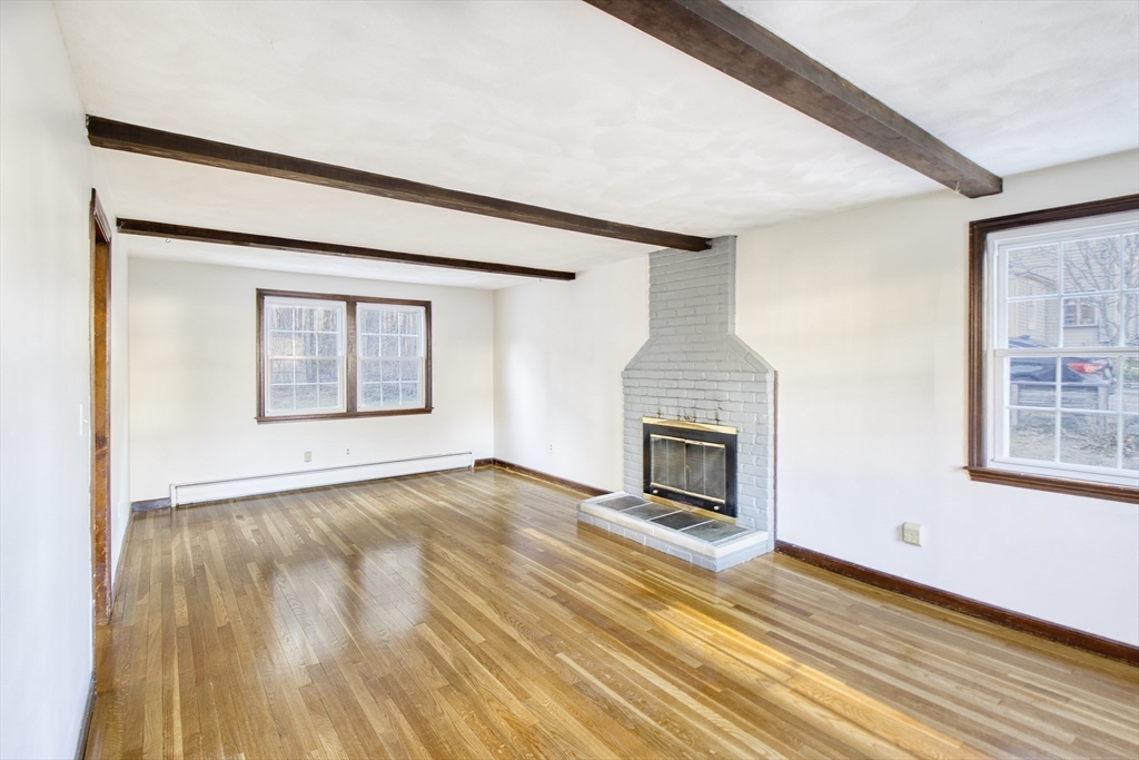 17 Colt Road Franklin, MA 02038 - Photo 10 of 40 a view of an empty room with wooden floor fireplace and a window