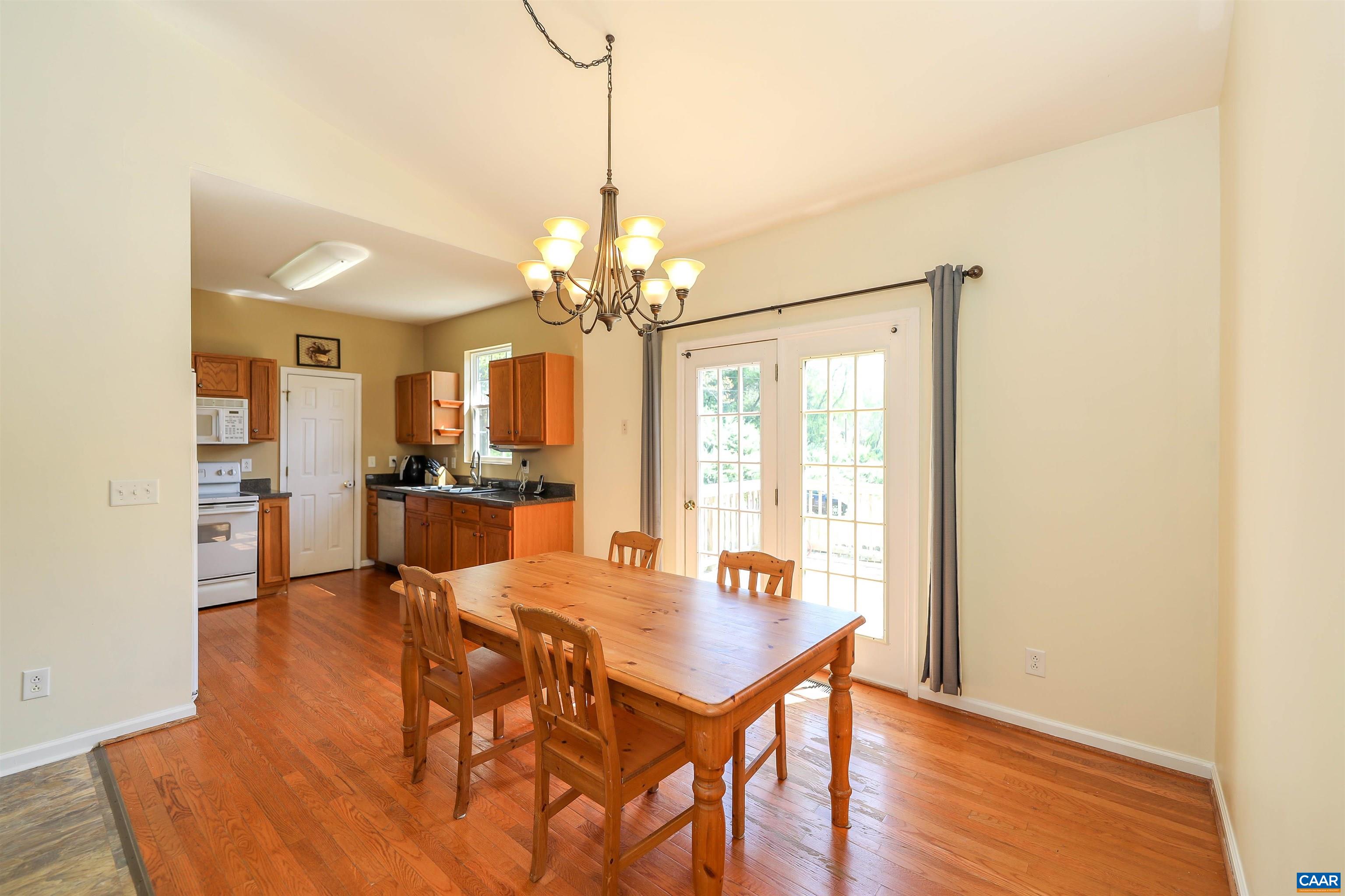286 Snapdragon Road Ruckersville, VA 22968 - Photo 16 of 44 a view of a dining room with furniture and wooden floor