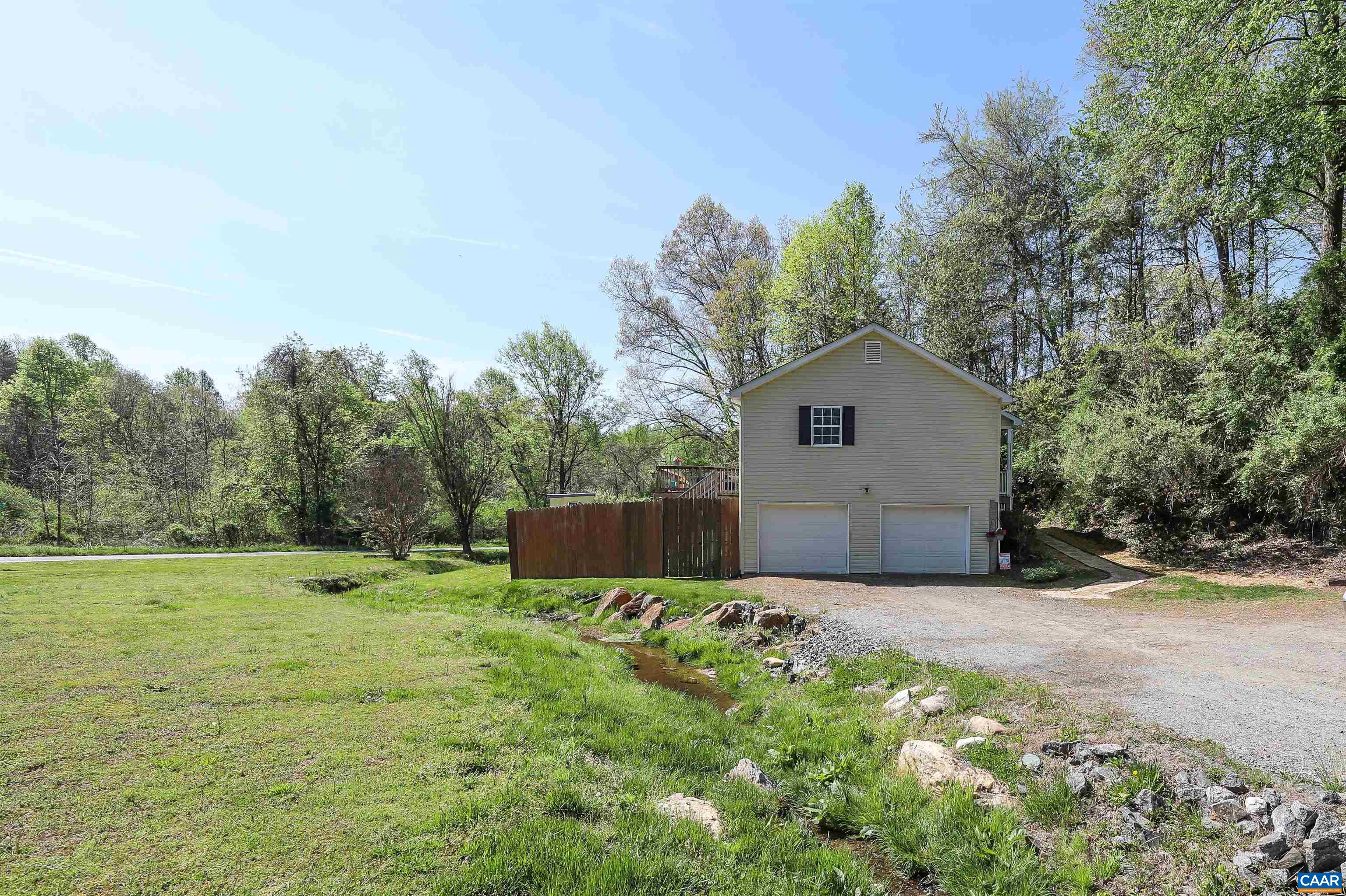 286 Snapdragon Road Ruckersville, VA 22968 - Photo 3 of 44 a front view of a house with a yard and trees