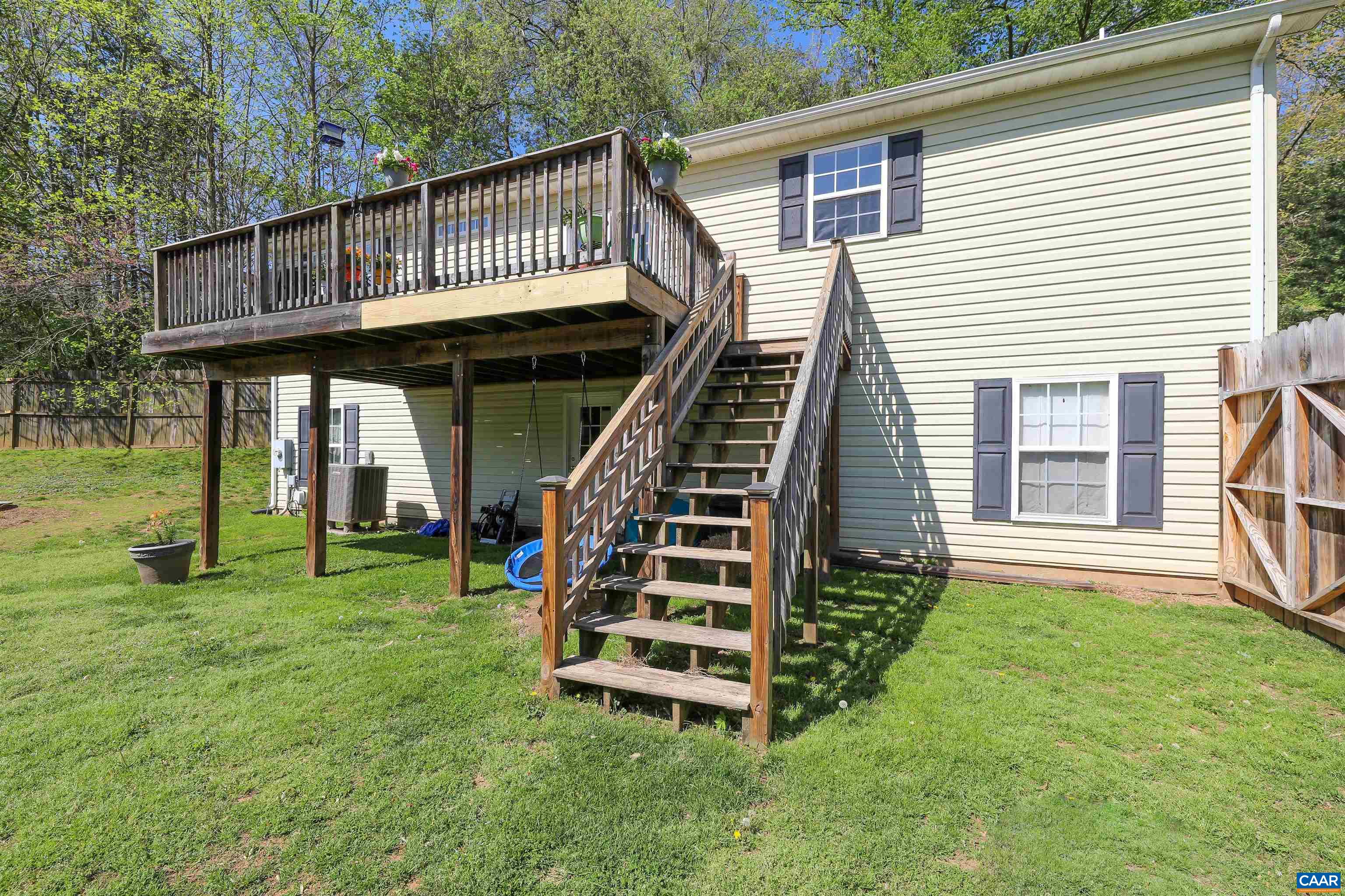 286 Snapdragon Road Ruckersville, VA 22968 - Photo 10 of 44 a view of a house with a deck and a yard with wooden floor